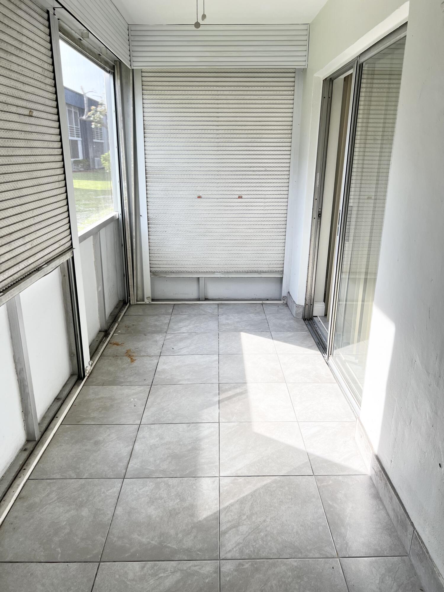 150 Burgandy Way, Unit D Delray Beach, FL 33484 - Photo 25 of 33 a view of a hallway to rooms
