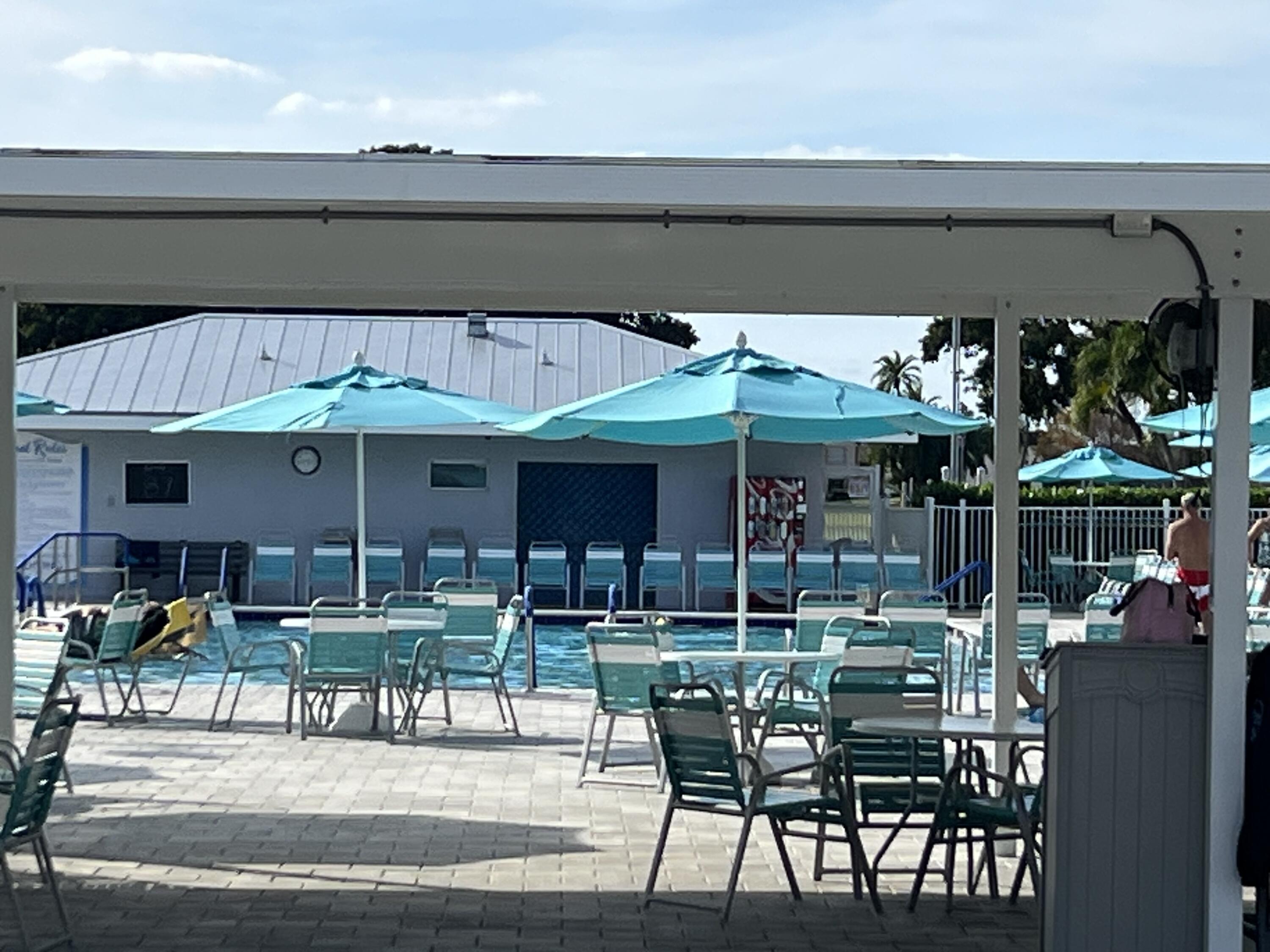150 Burgandy Way, Unit D Delray Beach, FL 33484 - Photo 30 of 33 a view of table and chairs in patio