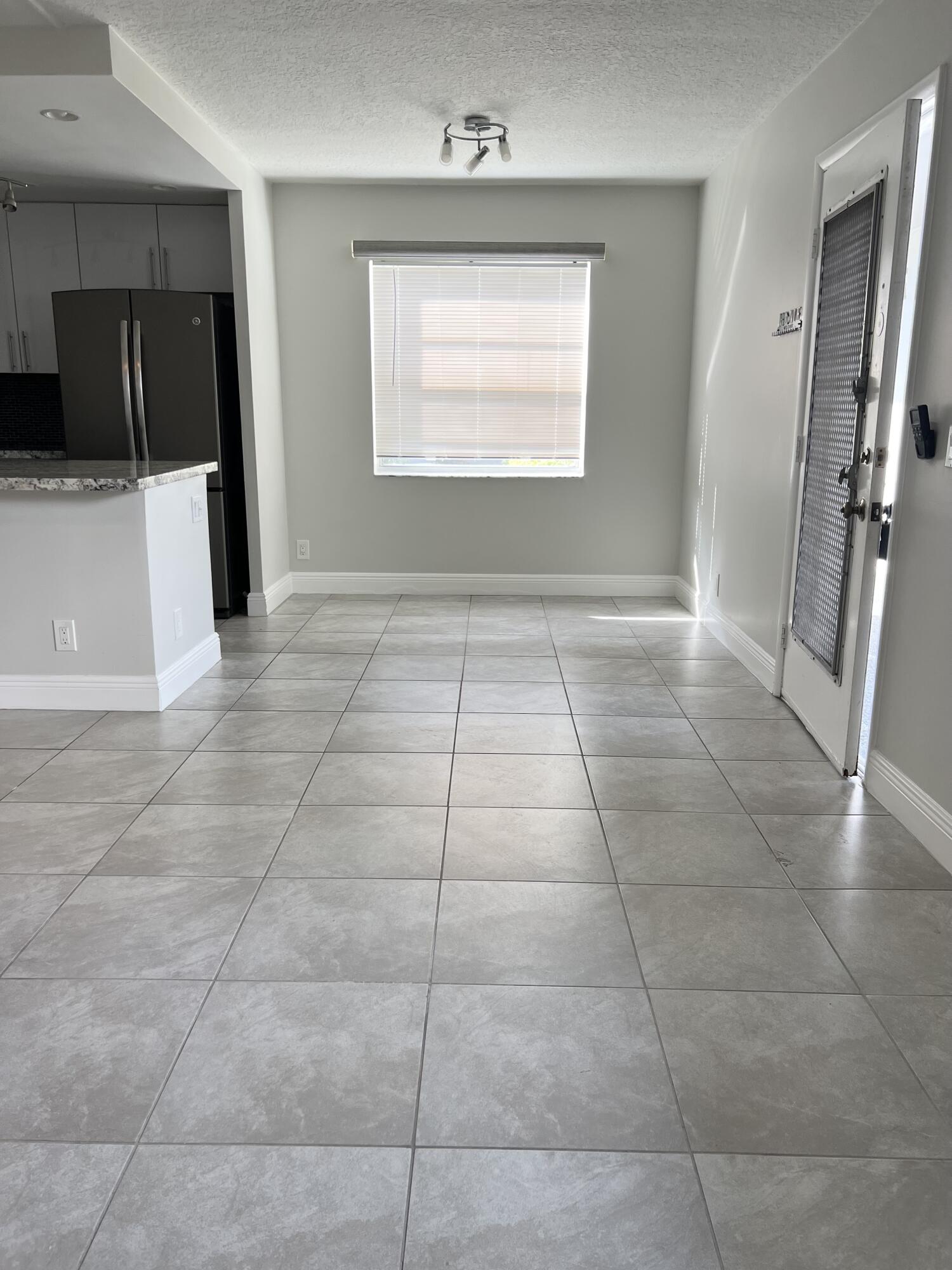 150 Burgandy Way, Unit D Delray Beach, FL 33484 - Photo 7 of 33 a view of an empty room with a kitchen