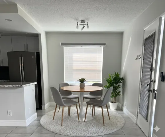 a dining room with furniture and window