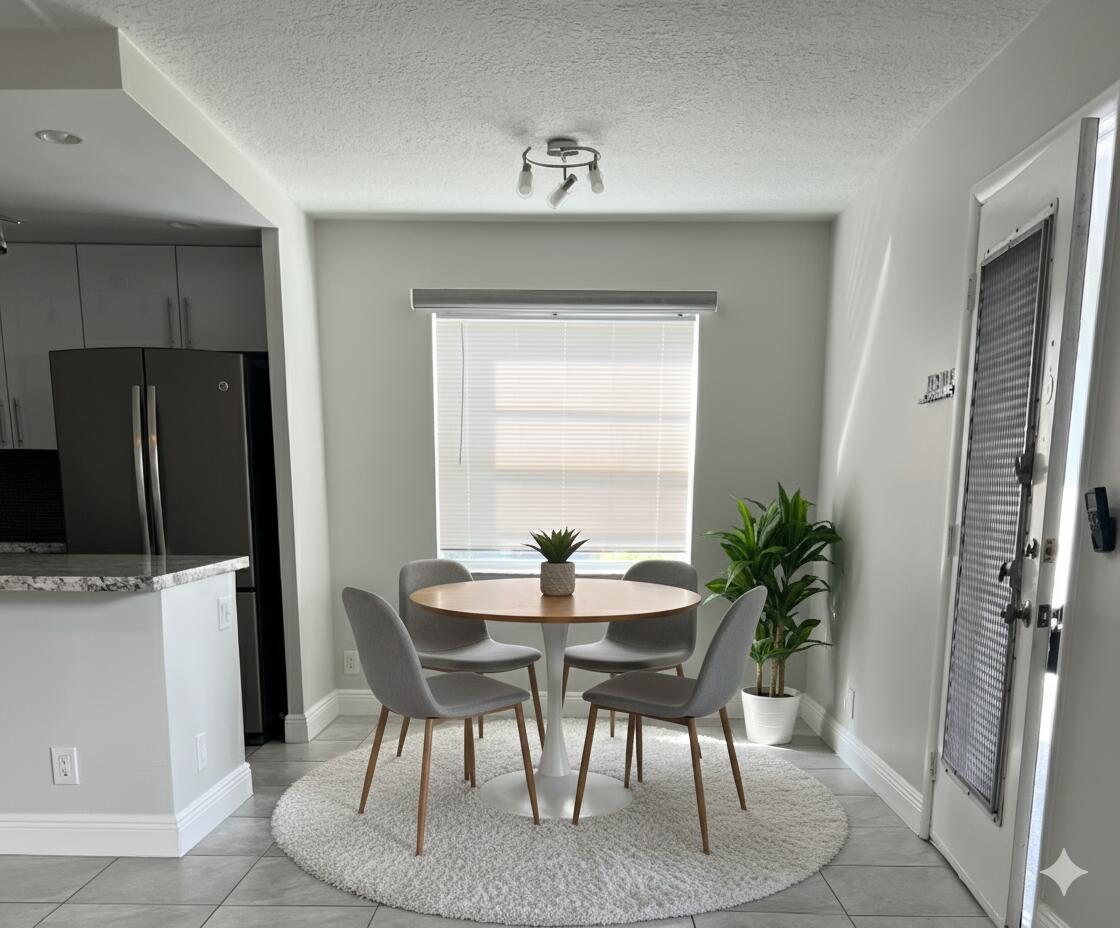 150 Burgandy Way, Unit D Delray Beach, FL 33484 - Photo 8 of 33 a dining room with furniture and window