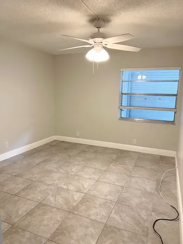 a view of a room with racks and a chandelier fan