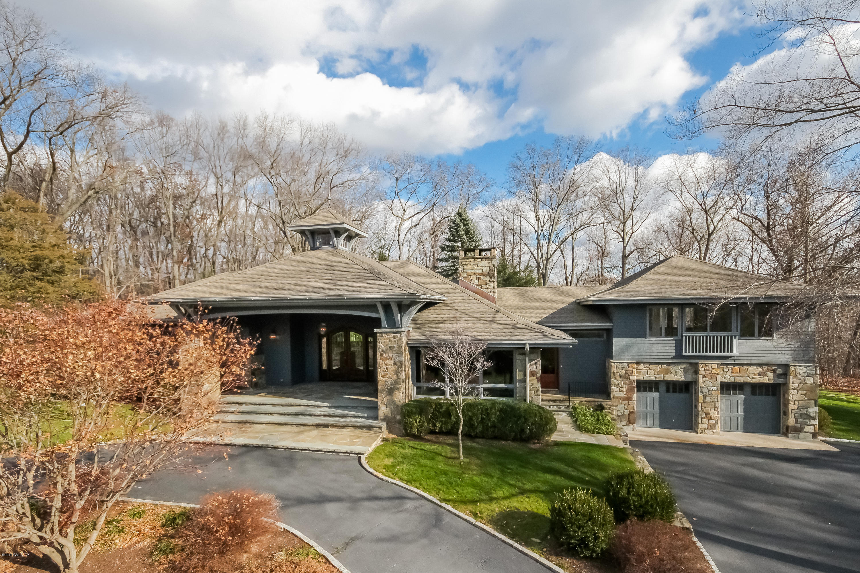 55 Cutler Road, Unit MAIN HOUSE Greenwich, CT 06831 - Photo 1 of 18 a front view of a house with a garden and trees