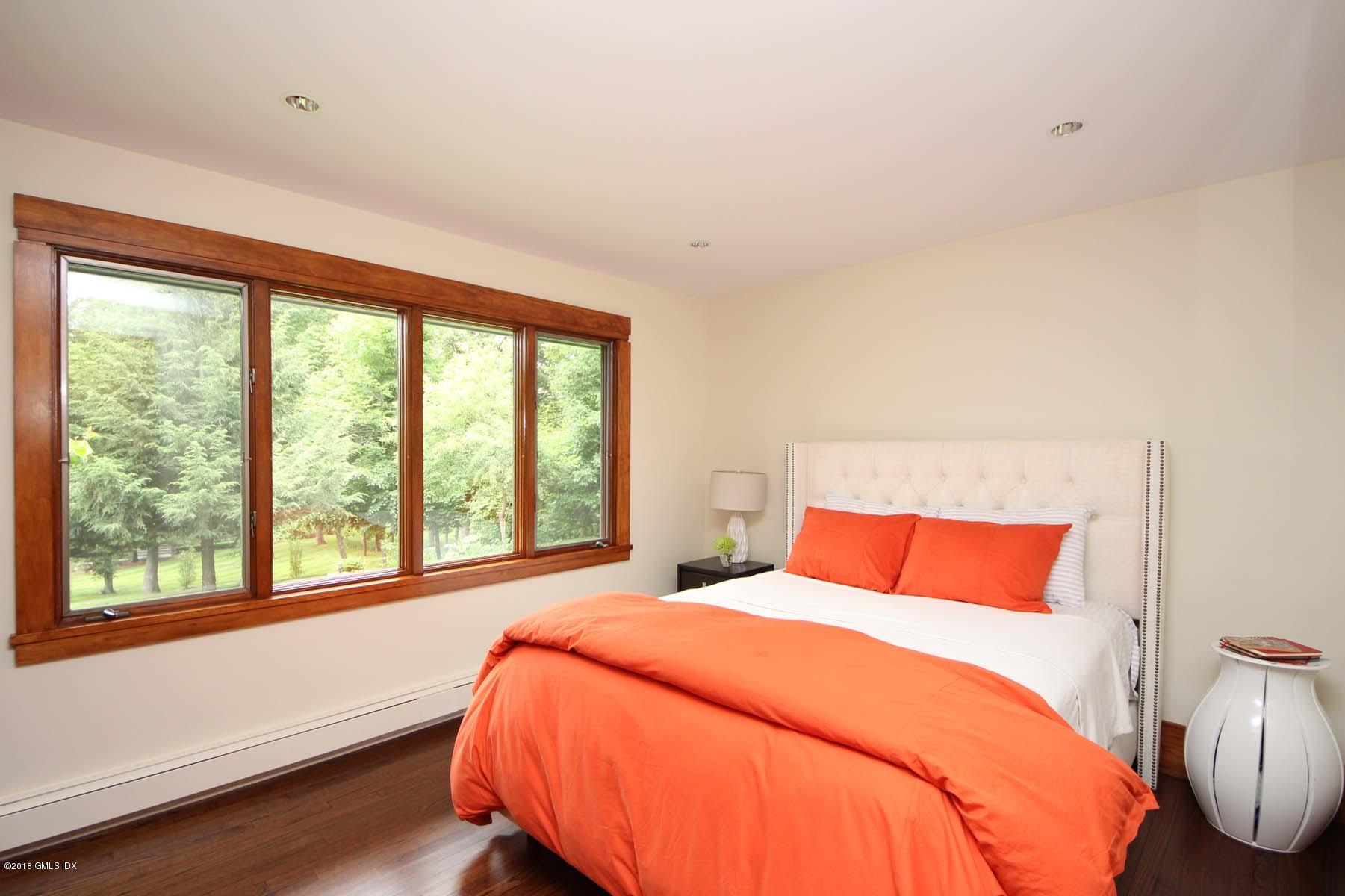 55 Cutler Road, Unit MAIN HOUSE Greenwich, CT 06831 - Photo 11 of 18 a bedroom with a bed and wooden floor