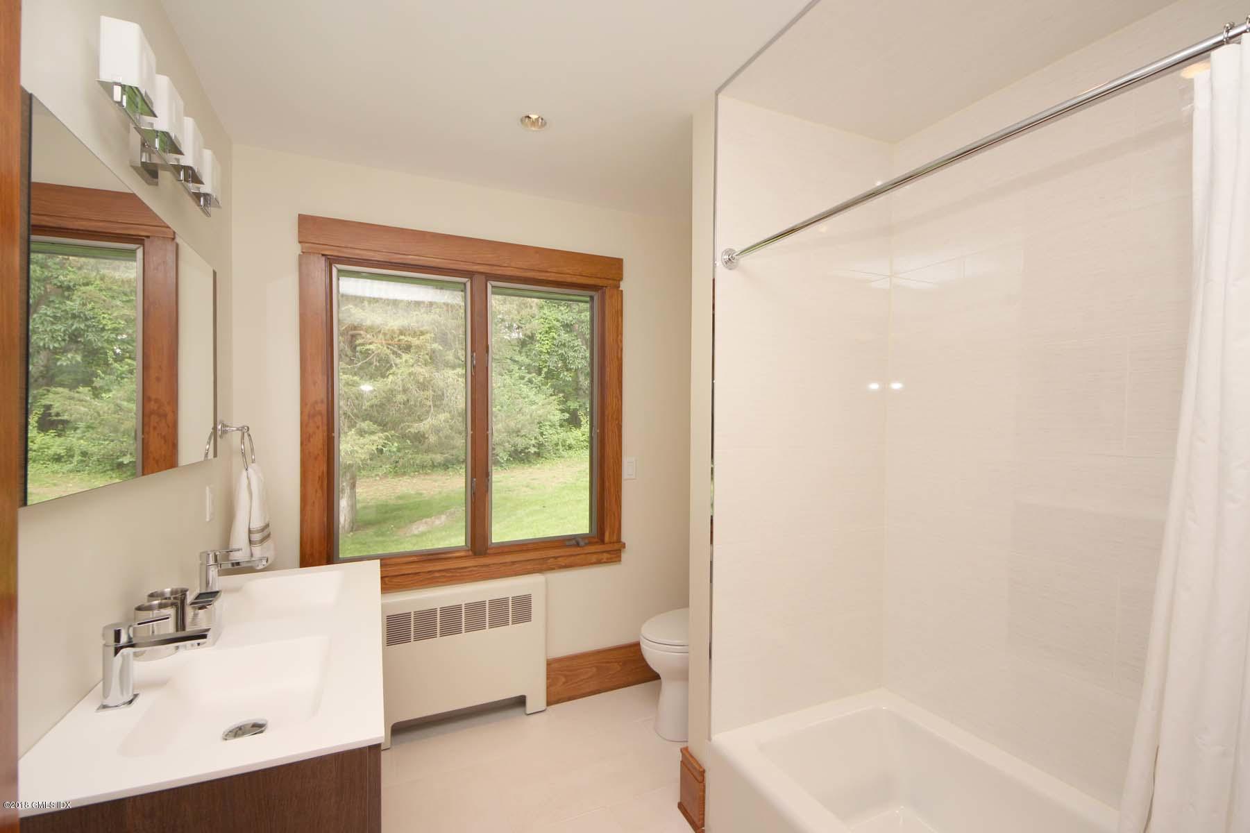 55 Cutler Road, Unit MAIN HOUSE Greenwich, CT 06831 - Photo 13 of 18 a bathroom with a bathtub and a sink