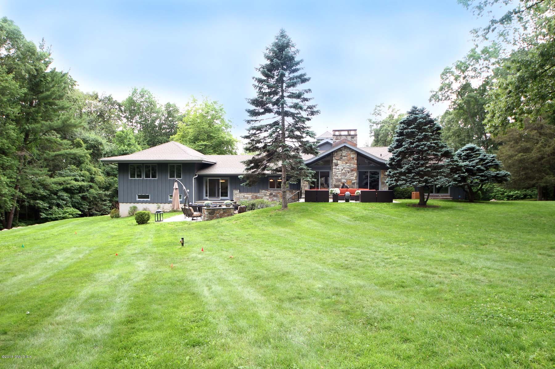 55 Cutler Road, Unit MAIN HOUSE Greenwich, CT 06831 - Photo 14 of 18 a front view of a house with garden