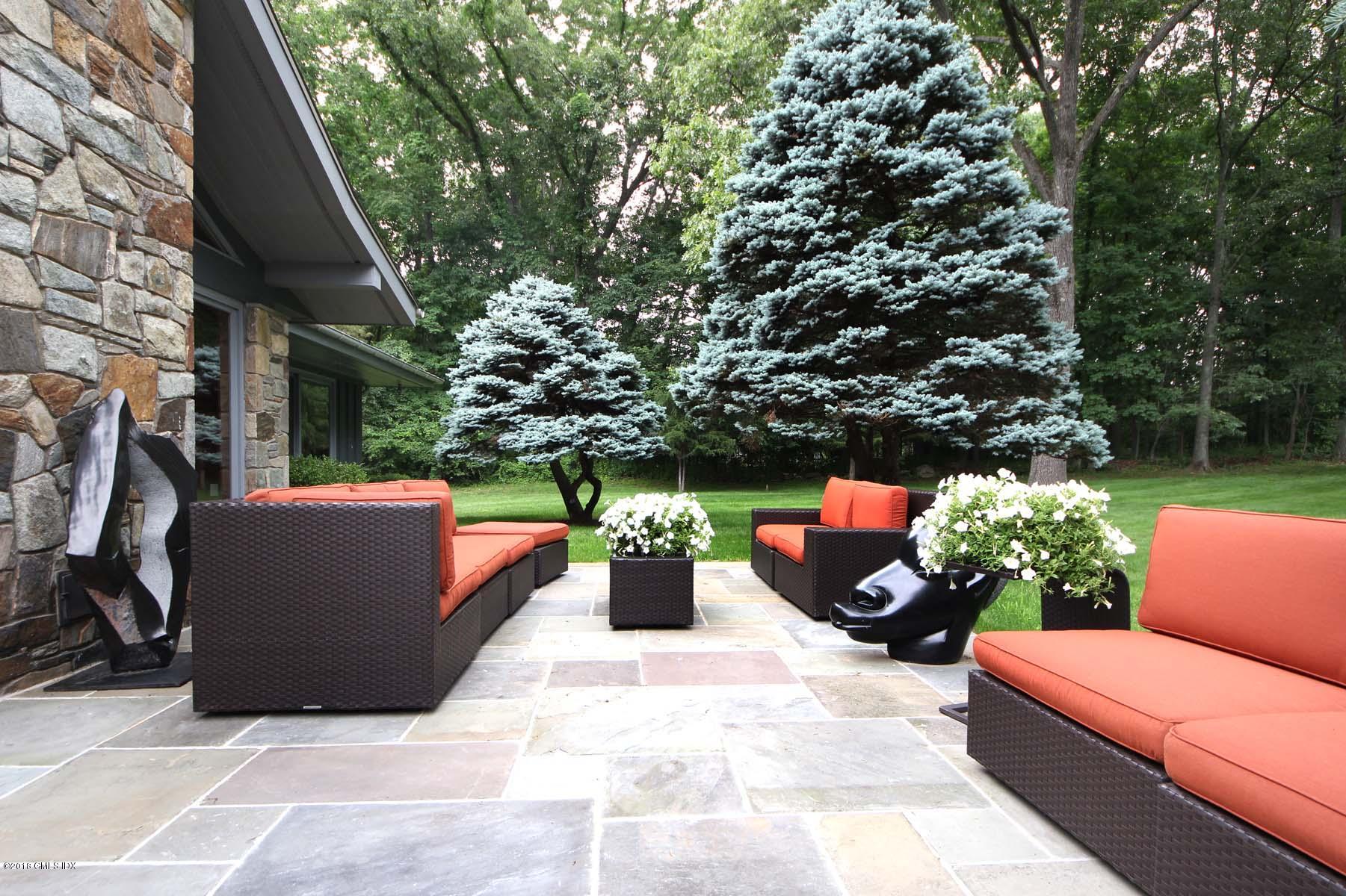 55 Cutler Road, Unit MAIN HOUSE Greenwich, CT 06831 - Photo 15 of 18 a backyard of a house with seating space