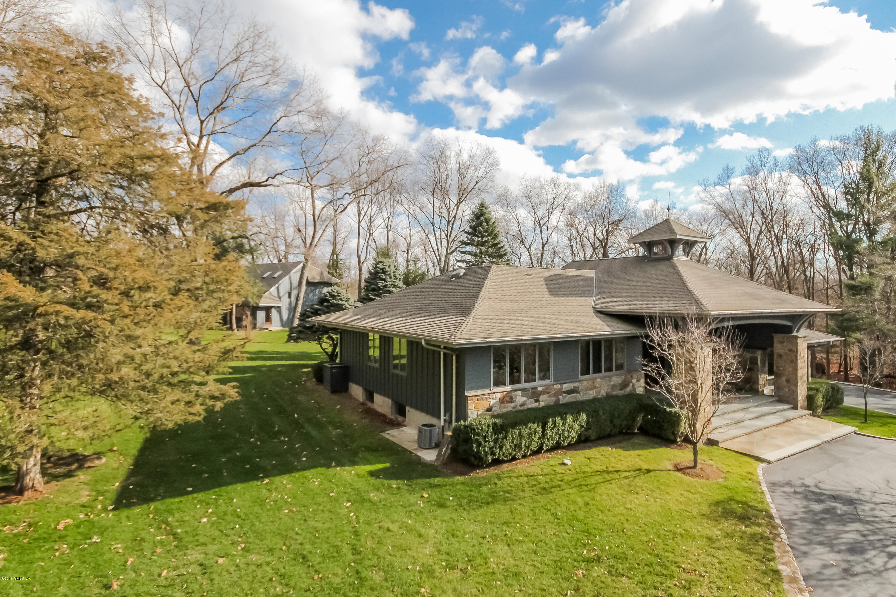 55 Cutler Road, Unit MAIN HOUSE Greenwich, CT 06831 - Photo 18 of 18 a view of a house with yard and sitting area