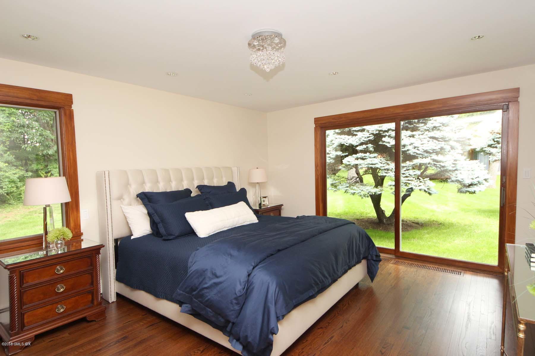 55 Cutler Road, Unit MAIN HOUSE Greenwich, CT 06831 - Photo 9 of 18 a bedroom with a bed and window