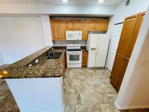 a kitchen with wooden cabinets and a stove