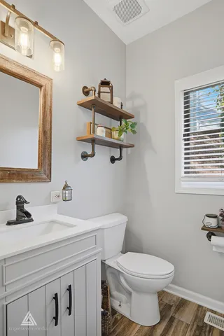 a view of a hallway with a livingroom and a chandelier