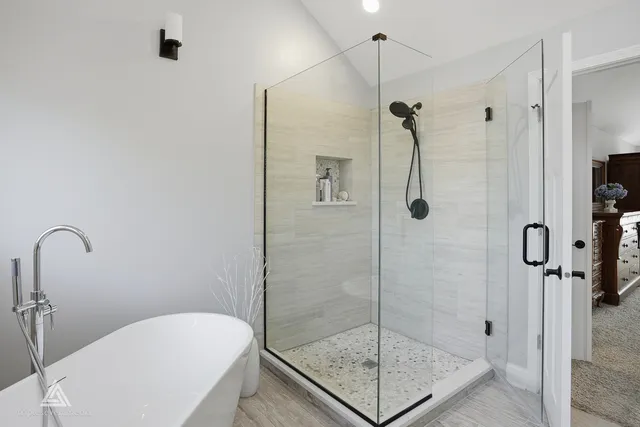 a bedroom with a bed table chair and a window