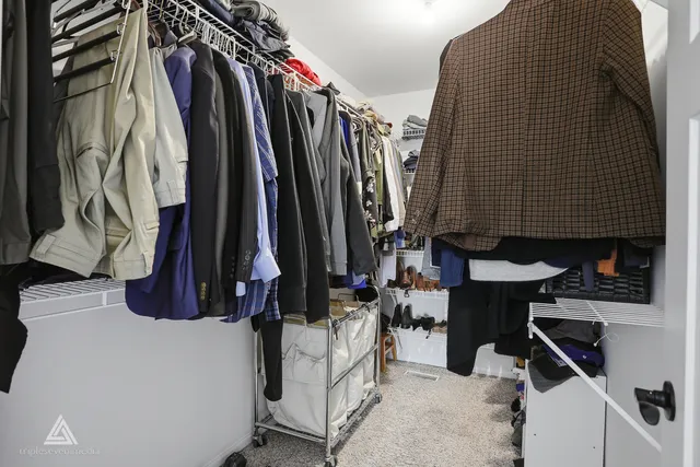 a bedroom with a bed and a television