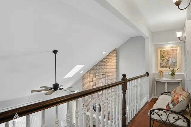 a dining hall with stainless steel appliances granite countertop a dining table and chairs with wooden floor