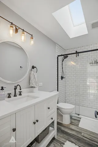 a kitchen with stainless steel appliances kitchen island granite countertop a sink and cabinets