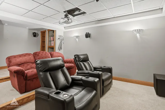 a front view of house with yard outdoor seating and covered with trees