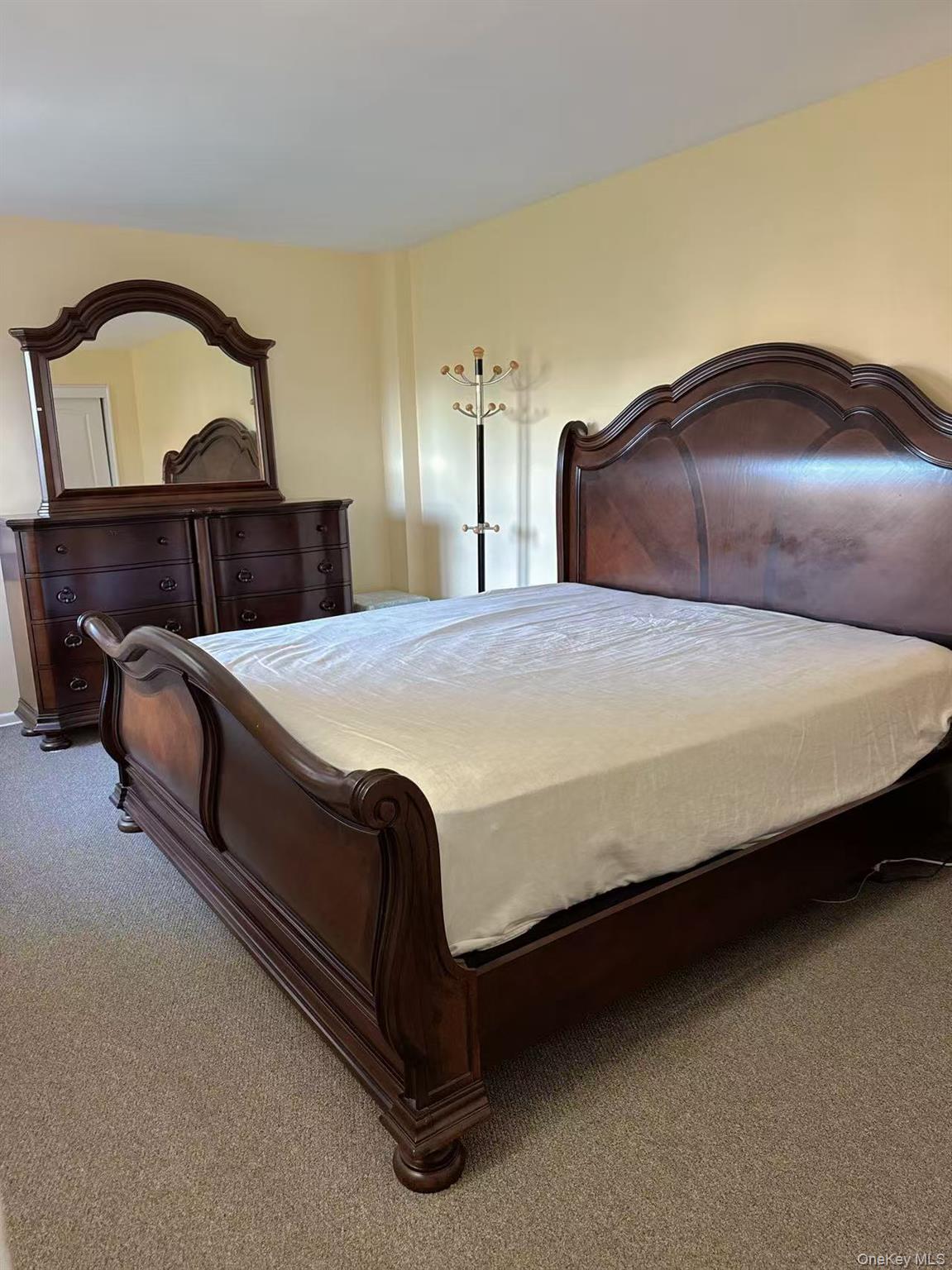 18-40 211th Street, Unit 5A Queens, NY 11360 - Photo 15 of 21 a bedroom with a bed and a mirror