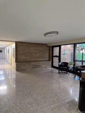 a lobby with furniture and a rug