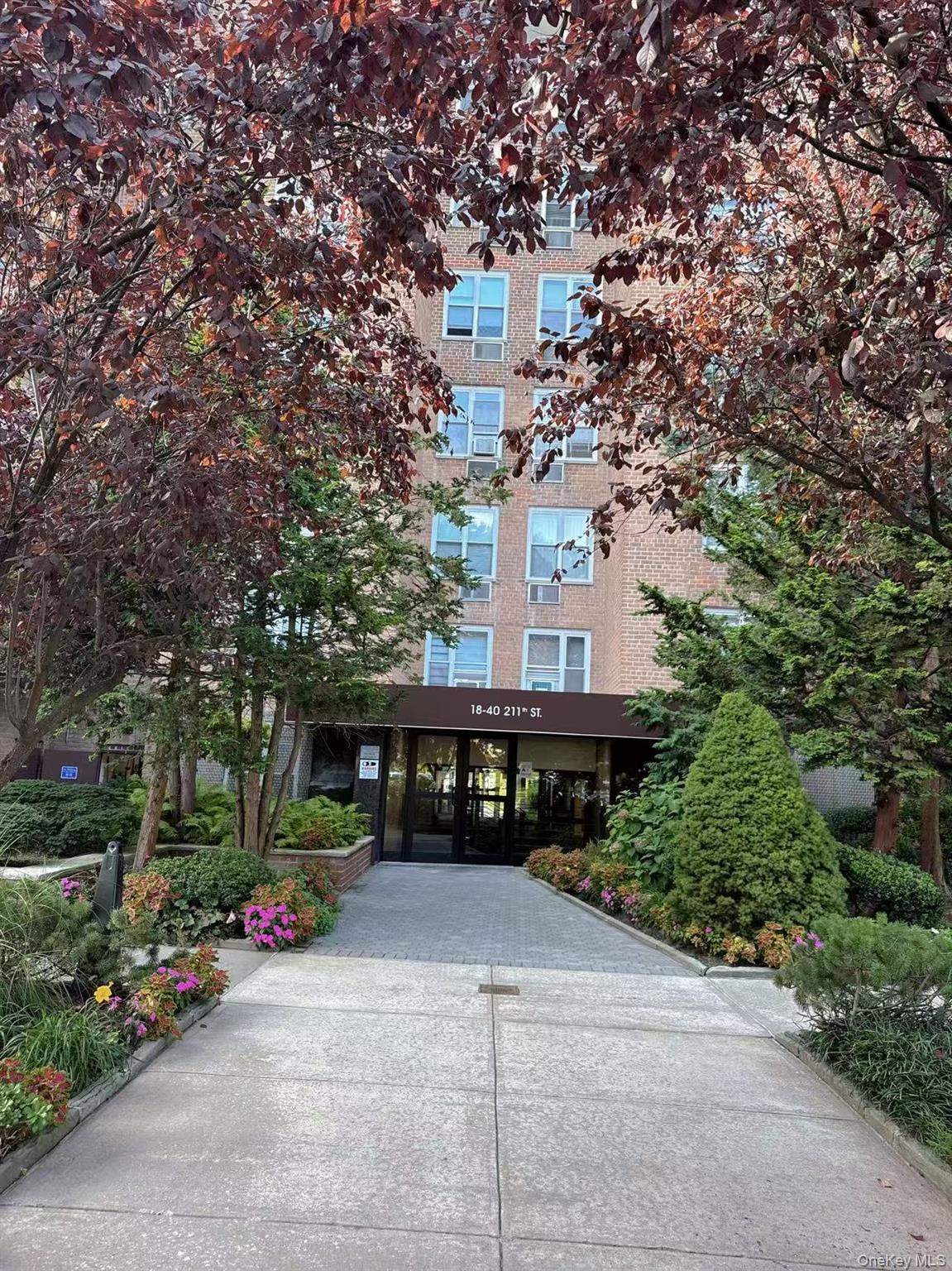 18-40 211th Street, Unit 5A Queens, NY 11360 - Photo 2 of 21 a front view of house with a yard