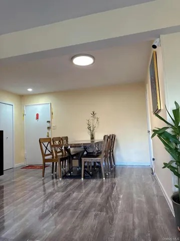 a view of a dining room with furniture and chandelier