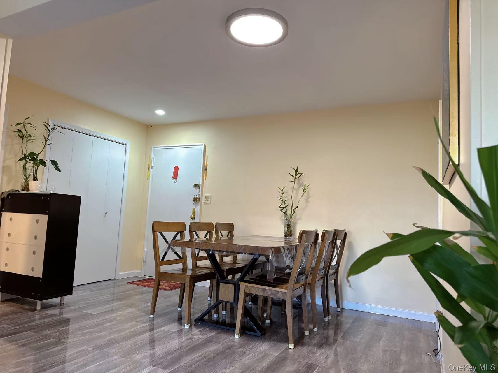 18-40 211th Street, Unit 5A Queens, NY 11360 - Photo 5 of 21 a view of a dining room with furniture and wooden floor
