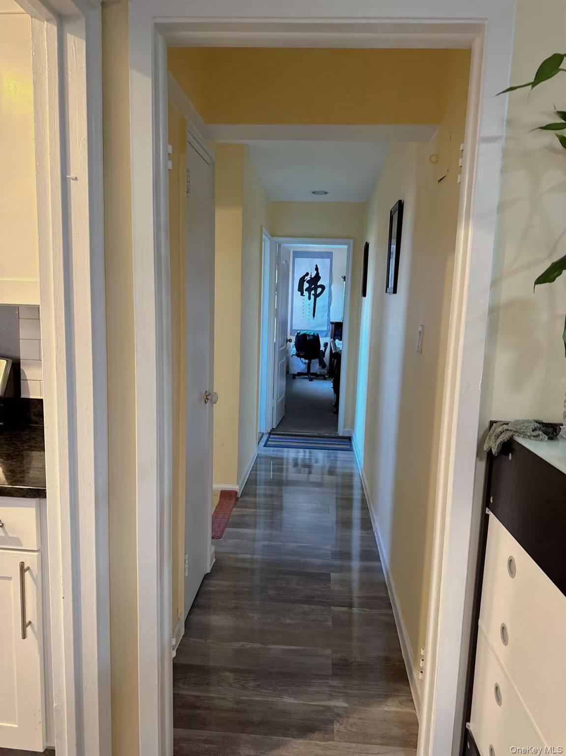 18-40 211th Street, Unit 5A Queens, NY 11360 - Photo 10 of 21 a view of a hallway with wooden floor and staircase