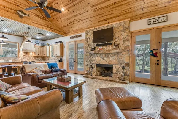 a living room with furniture a fireplace and a flat screen tv