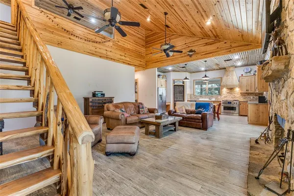 a living room with furniture and a chandelier
