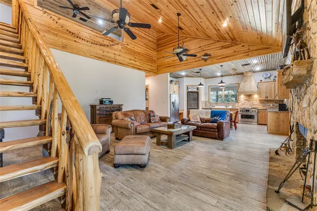 a living room with furniture and a chandelier