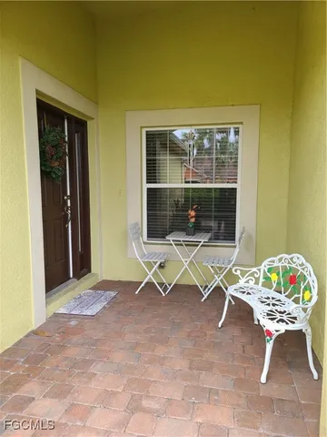 a view of a hallway with wooden floor and glass top door