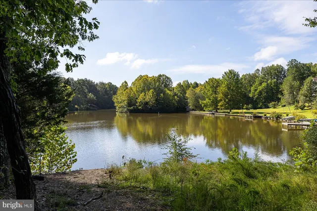a view of a lake in between two and trees