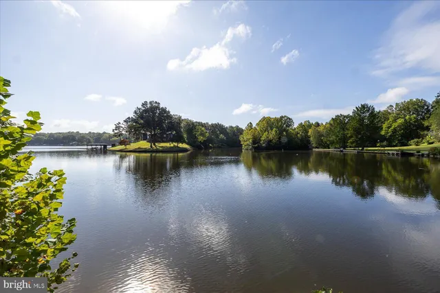 a view of a lake with houses in the back