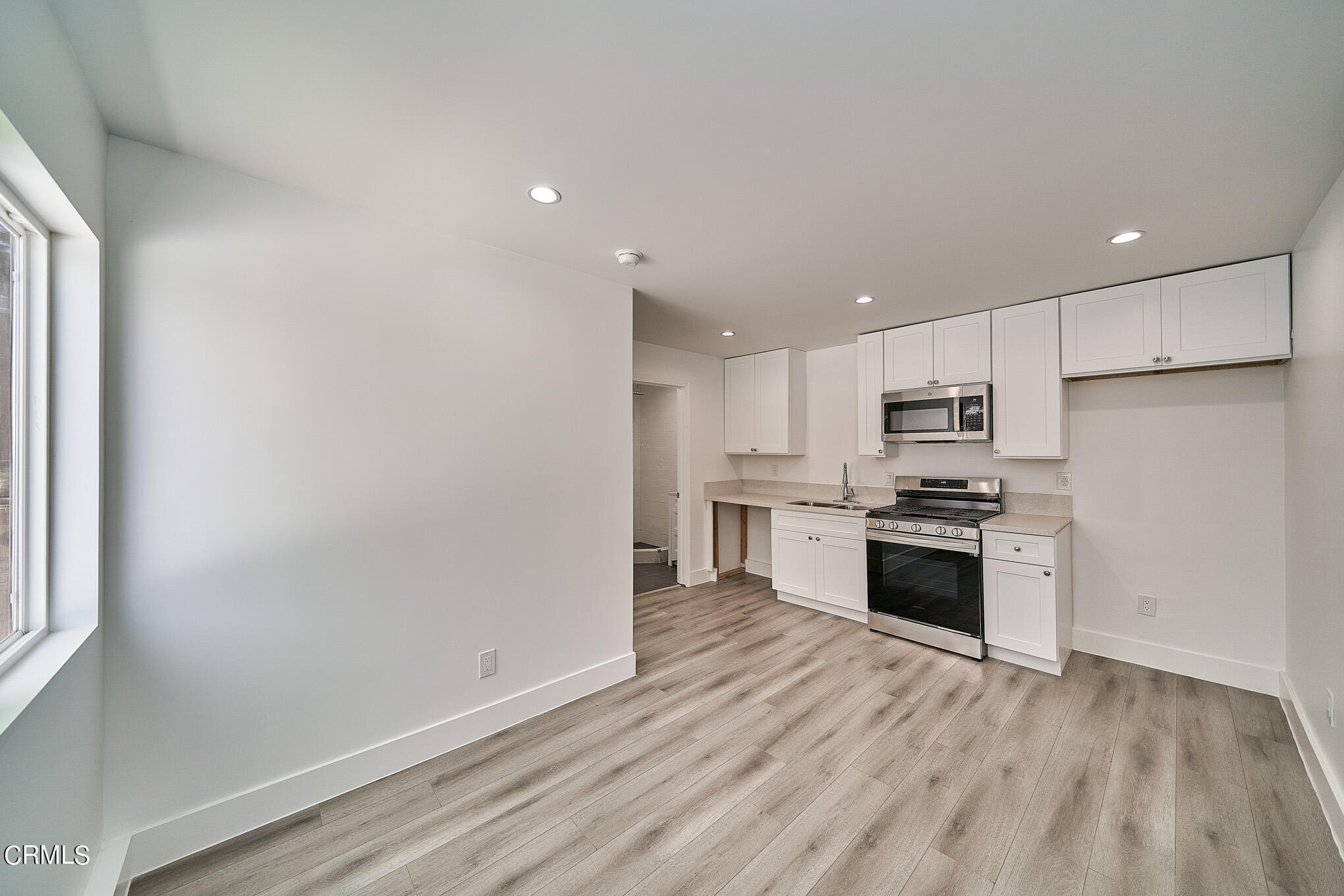 3623 A 3rd Avenue Glendale, CA 91214 - Photo 4 of 20 a kitchen with stainless steel appliances a refrigerator sink and stove top oven