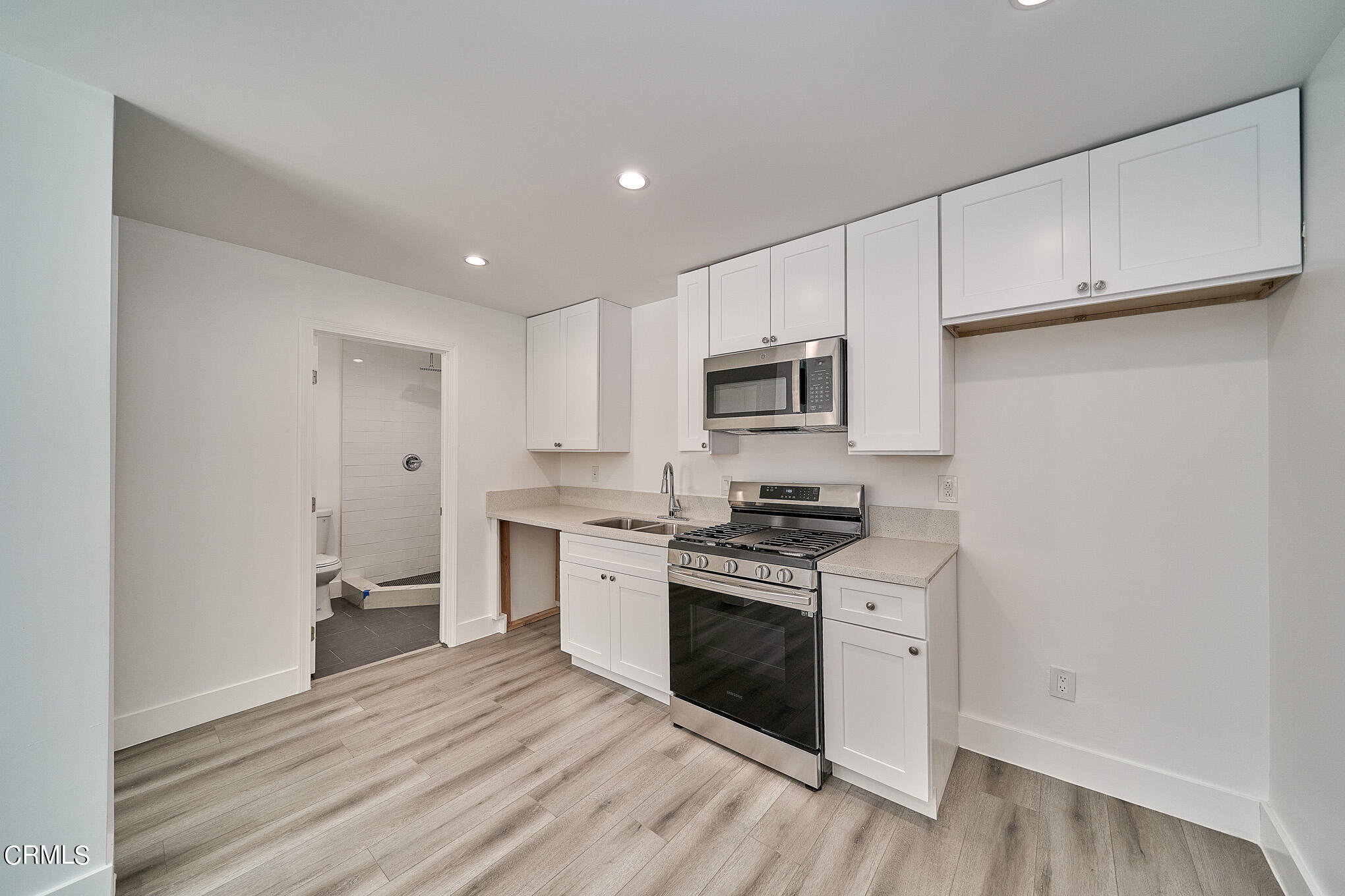 3623 A 3rd Avenue Glendale, CA 91214 - Photo 6 of 20 a kitchen with cabinets stainless steel appliances and wooden floor