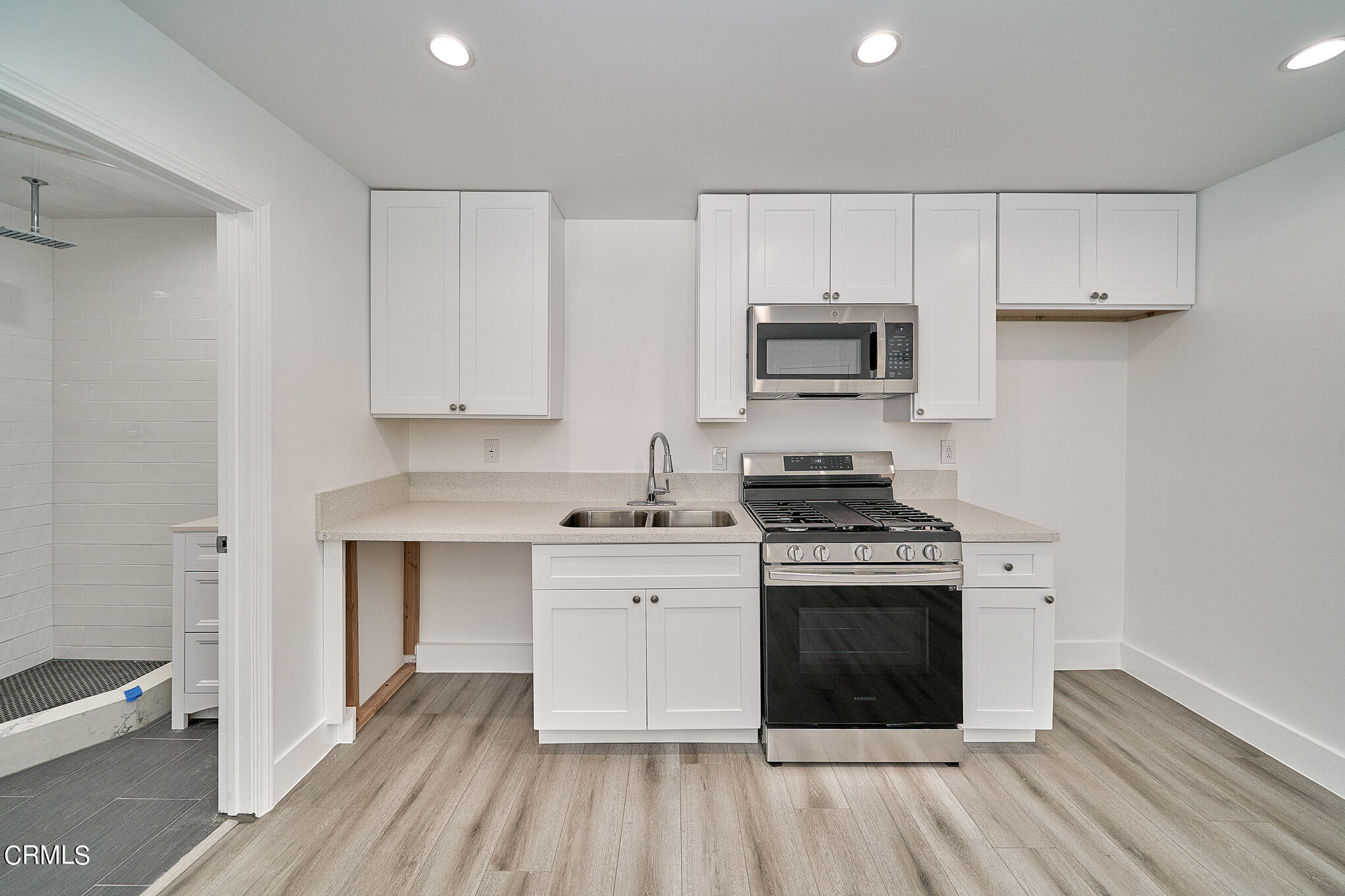 3623 A 3rd Avenue Glendale, CA 91214 - Photo 7 of 20 a kitchen with cabinets wooden floor and a sink