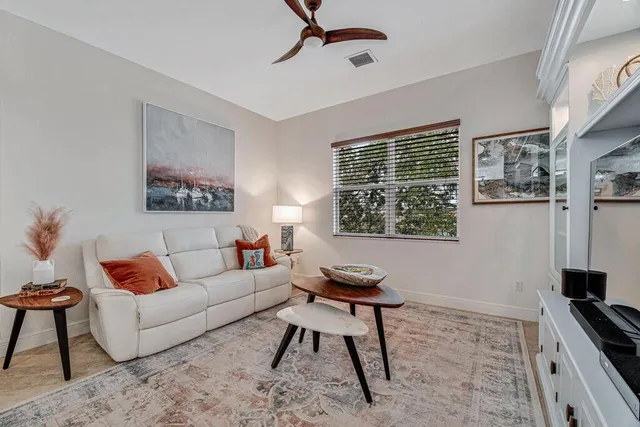 a living room with furniture and a lamp