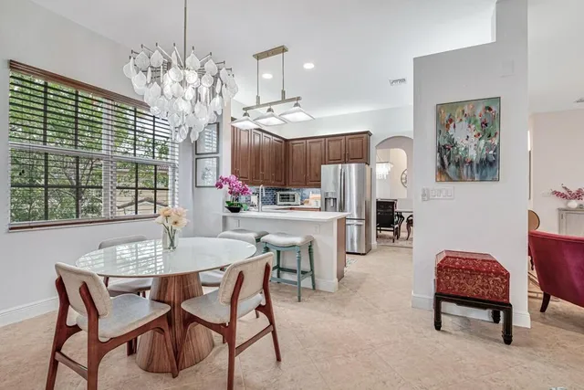 a kitchen with granite countertop wooden cabinets and stainless steel appliances