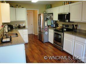 371 Planters Creek Road Fletcher, NC 28732 - Photo 11 of 24 a kitchen with a sink a stove and a microwave