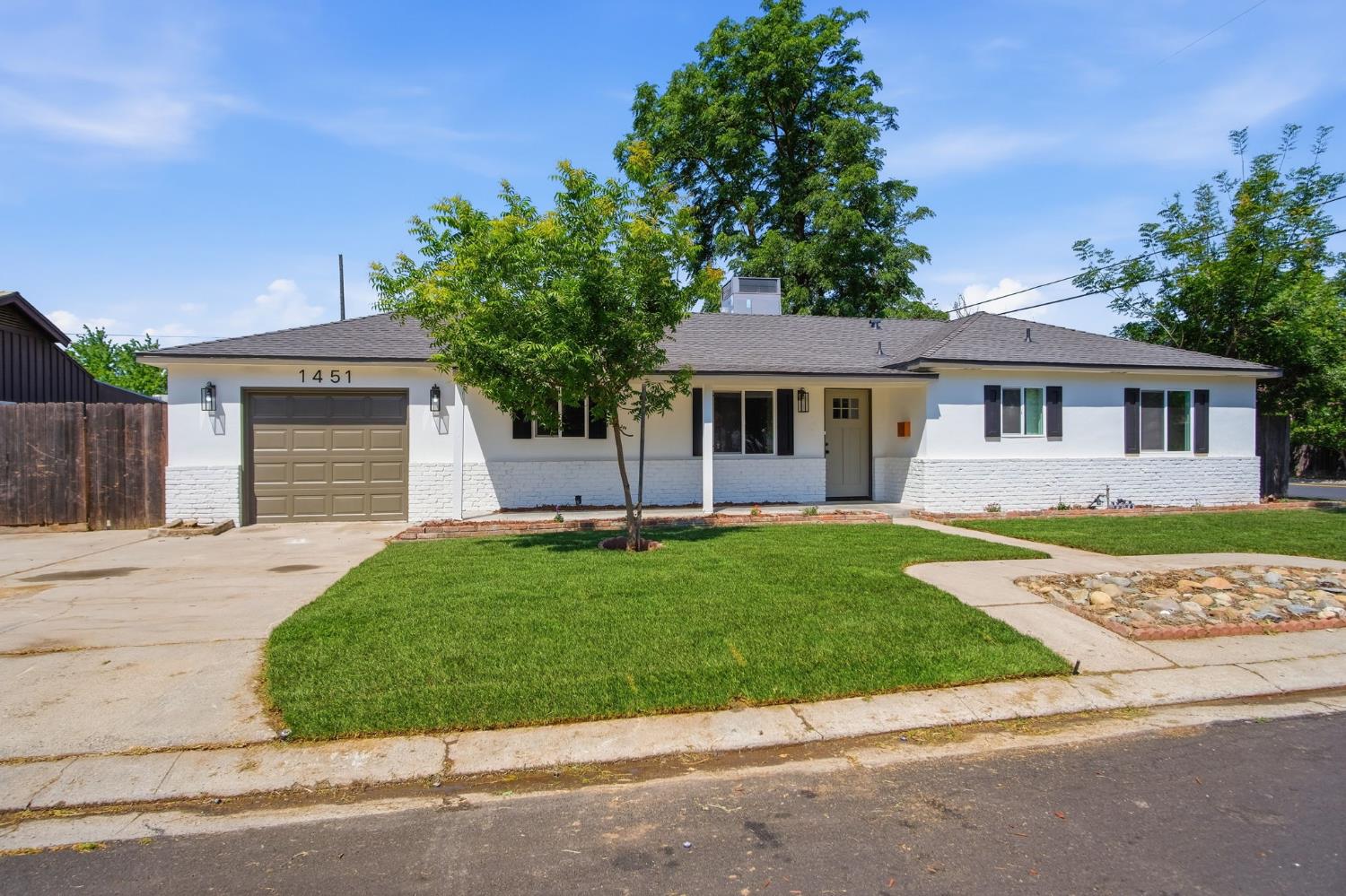 1451 Kent Way Modesto, CA 95355 - Photo 2 of 37 front view of a house with a garden