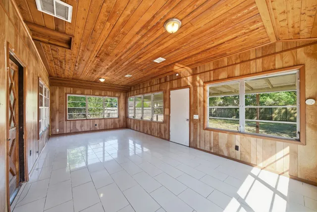 a view of hallway with a large window and chandelier