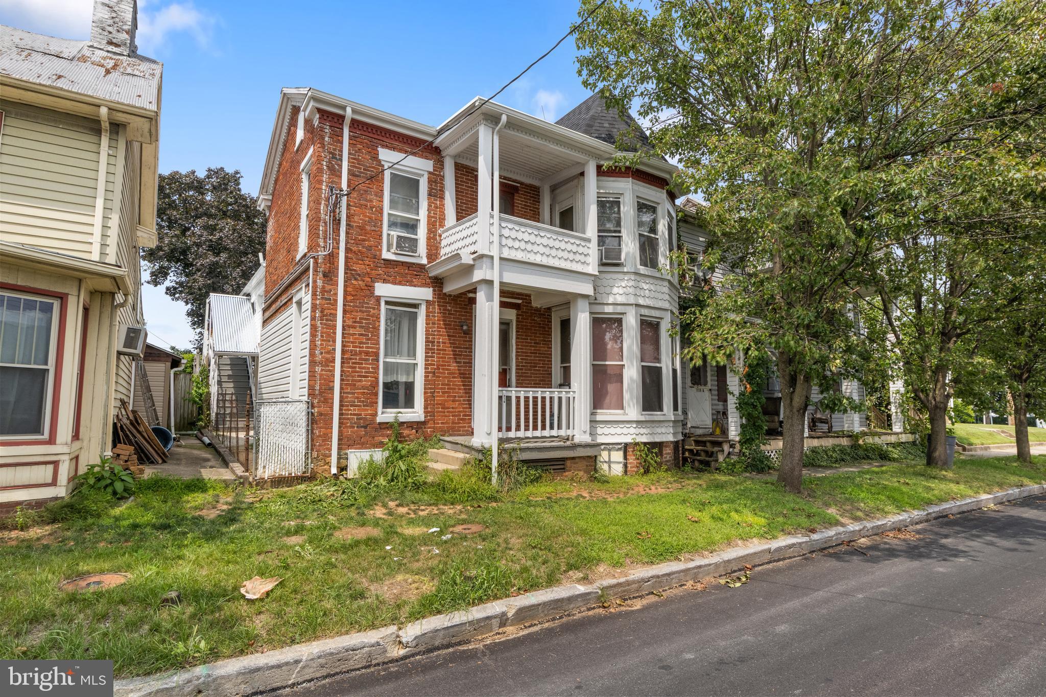 216 Main Street New Windsor, MD 21776 - Photo 2 of 16 a front view of a house with a yard