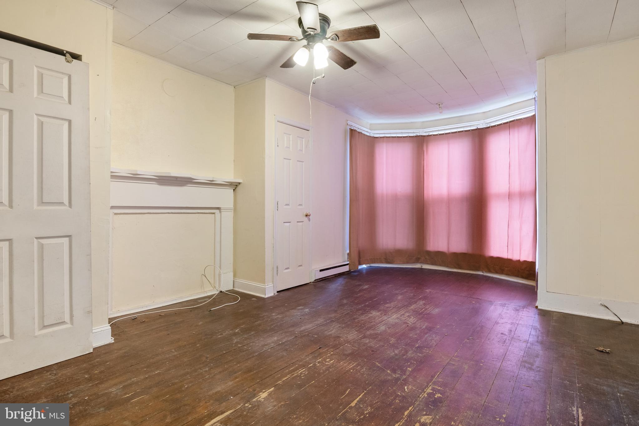 216 Main Street New Windsor, MD 21776 - Photo 4 of 16 a view of an empty room with a window