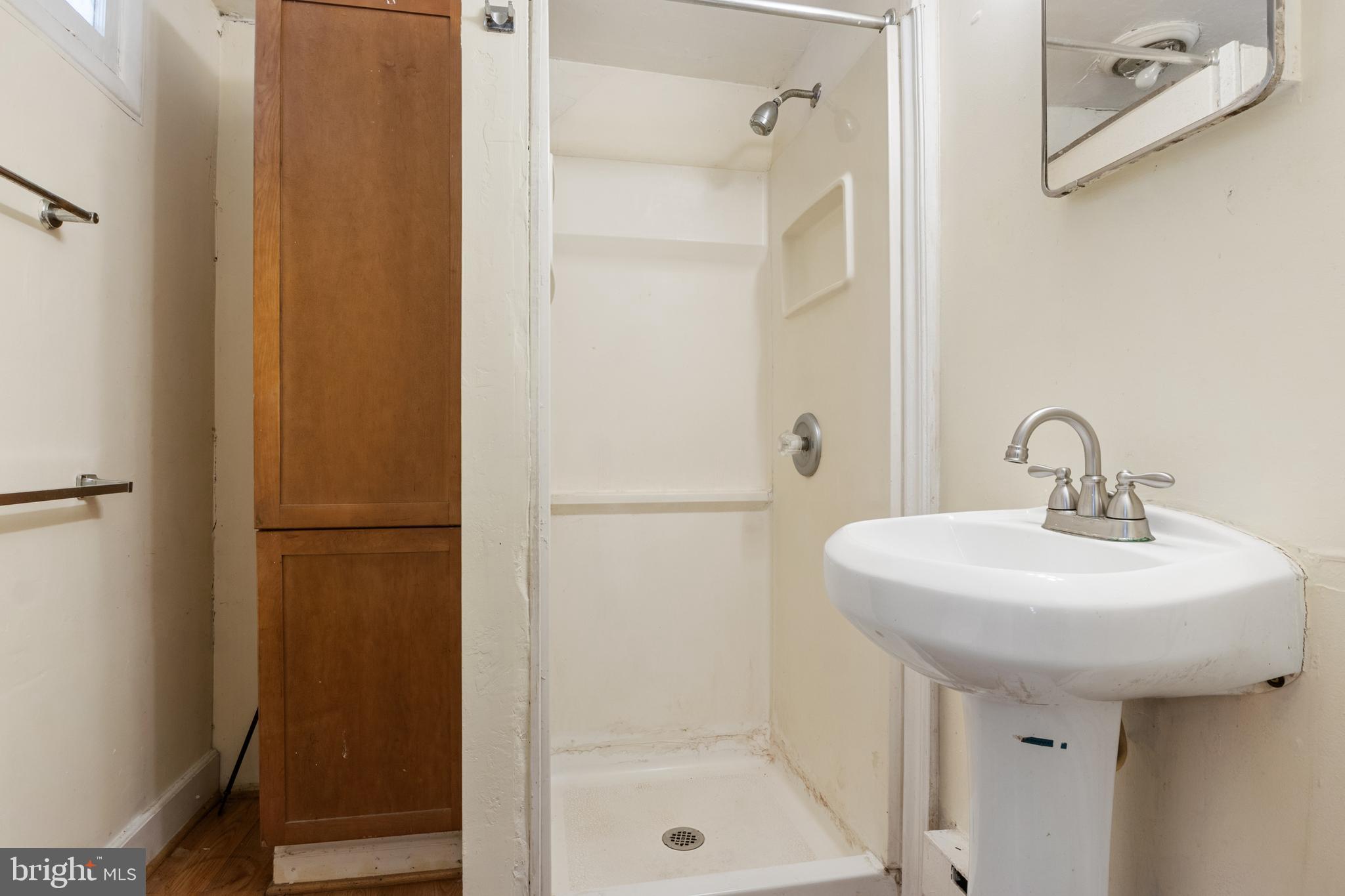 216 Main Street New Windsor, MD 21776 - Photo 8 of 16 a bathroom with a sink a toilet and shower