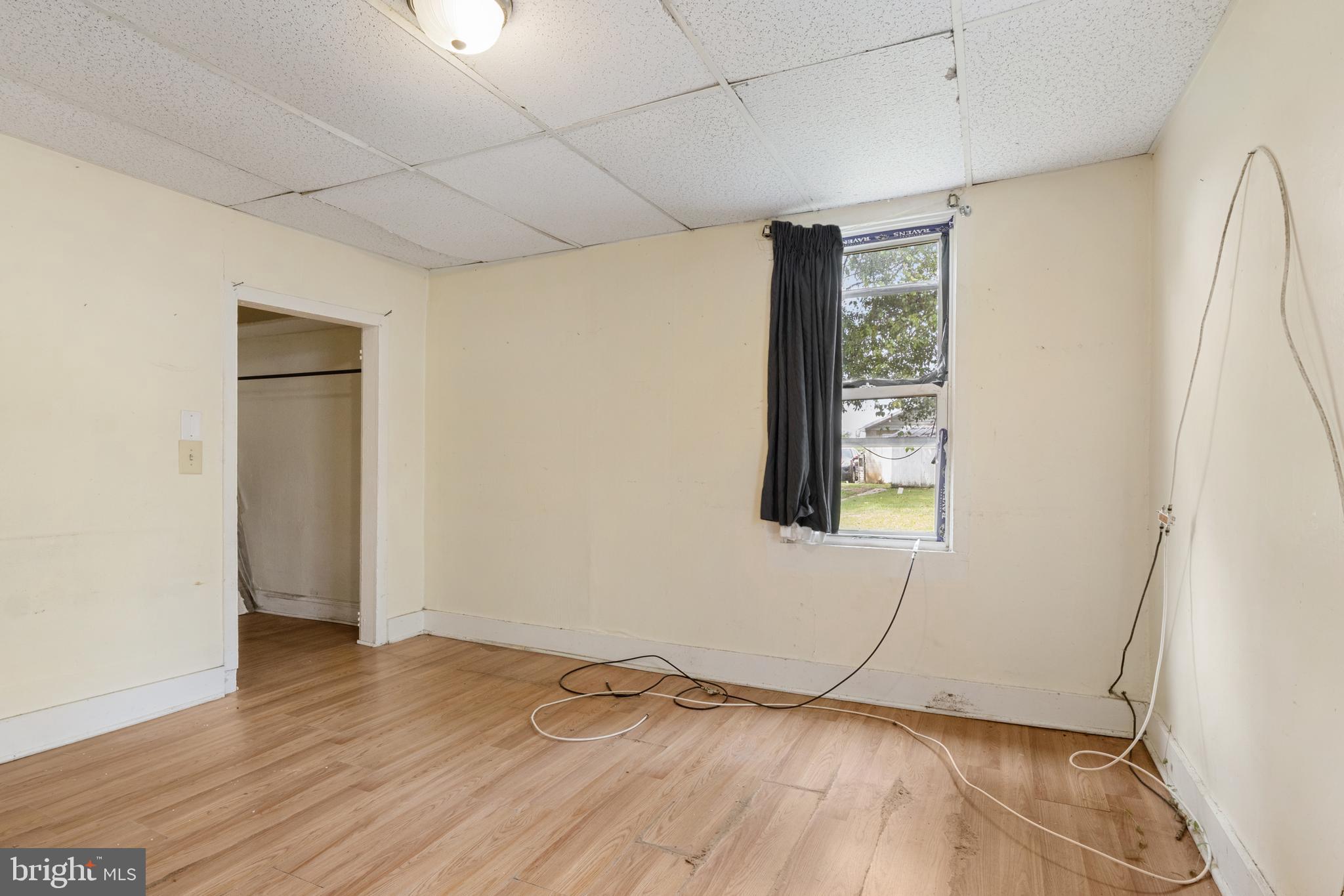216 Main Street New Windsor, MD 21776 - Photo 9 of 16 a view of an empty room with wooden floor and a window
