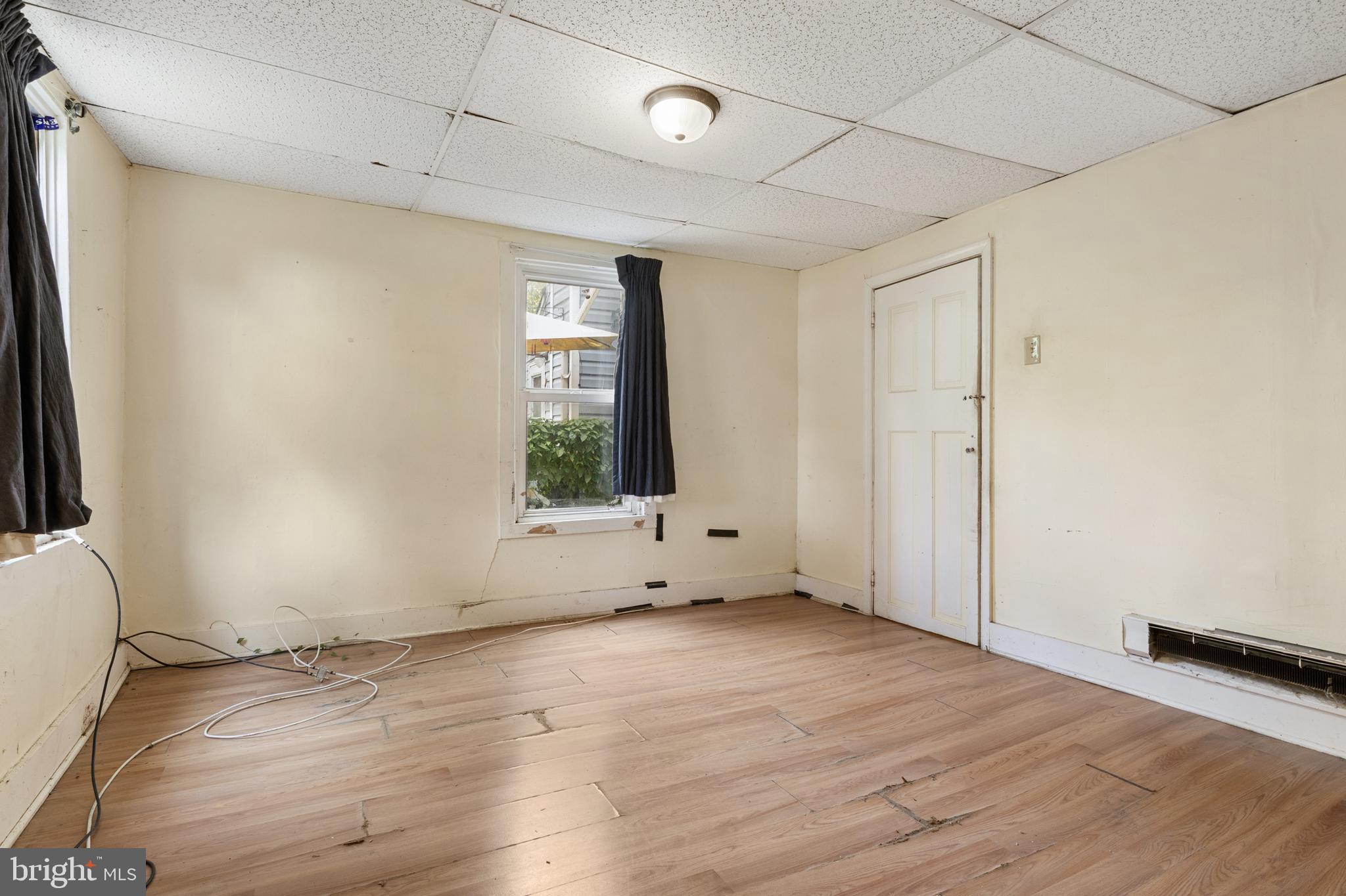 216 Main Street New Windsor, MD 21776 - Photo 10 of 16 an empty room with wooden floor and windows