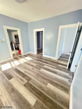 a view of a livingroom with wooden floor and stairs