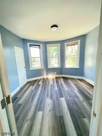 a view of wooden floor and windows in a room