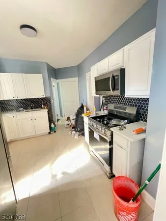 a kitchen with a stove and a refrigerator