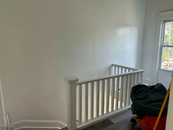 a view of a bedroom with furniture and a window