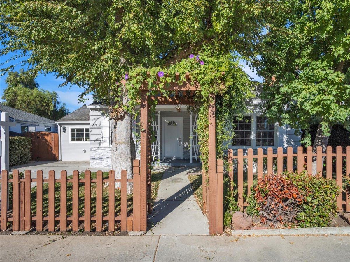 a front view of a house with a garden